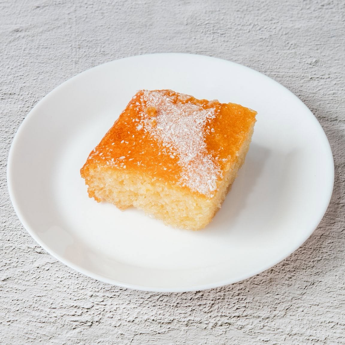 Mr Gyros zesty homemade filo orange cake filled with a thick golden syrup.